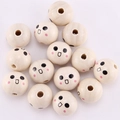 20mm natural wood smiley face beads with pink cheeks scattered on soft fabric - Astonished