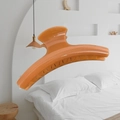 Detail of a large 15cm glossy orange French hair claw clip over a bedroom background - Butterfly Back Style / Extra Large (Approx. 15cm) / Sandalwood Orange