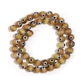 Amber evil eye glass beads for DIY necklaces and bracelets on white background - Earthy Yellow