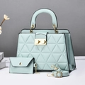 Macro view of mint green quilted handbag set including a matching pouch and adjustable strap - Green