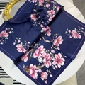 Elegant navy blue square silk scarf with pink magnolia floral print on white table - Navy Blue