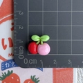 Mini resin red and pink cherry charms with green leaves on a measuring mat - Pink and Dark Red Cherry