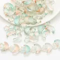 Detailed view of iridescent star and moon shaped glass beads for DIY jewelry making - Dawn Color