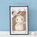 Creamy white coral fleece towel folded into a rabbit shape in a boutique gift bag - Beige + Leaf Gift Box