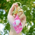 Pink marbled conch keychain with golden ring lobster clasp and small bell charm accessory - Pink