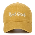 Close-up of 'Bad Bitch' white embroidery on washed cotton mustard yellow baseball cap - Yellow