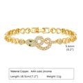 Detailed view of gold snake bracelet with AAA cubic zirconia and green gem eyes - Snake with Green Eyes