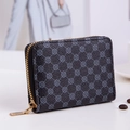 Mini square zip wallet with quilted clover print and golden hardware on white surface - Black
