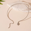 Detailed view of silver snake choker with white pavé zircons on stone background - Snake Rhinestone Choker / Silver