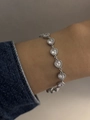 Close-up of a silver heart-shaped link bracelet with white zircon on a woman wrist - Continuous Heart Chain Style (B817)