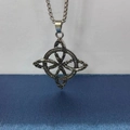 Macro view of silver Slavic necklace with intricate Viking knot pendant design - Silver + Stainless Steel Chain