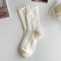 Detail of cream calf-high socks featuring ruffle cuffs and geometric knit texture - Frill Edge