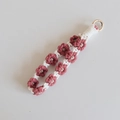 Detail view of handmade woven flower phone strap with pink and white cotton daisy pattern - Brick Red