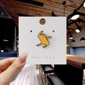 Cute yellow cartoon enamel pin with dynamic dance pose on white display card - 161*Sad Cartoon Figure