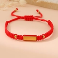 Close-up of red braided rope bracelet with polished gold metal plate and adjustable closure - Red (Gold Plate)