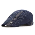 Close-up of navy blue quilted flat cap showing white diamond stitching and M logo detail - M Label Patchwork Style / Navy Blue