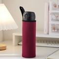 Dark red fabric water bottle sleeve with strap on a desk for heat insulation - Burgundy