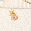 Macro shot of a gold-plated hat character pendant with pink heart-shaped gemstone inlay - Pink (Humanoid Style)