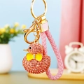 Detail of pink rhinestone duck keychain with gold ring and pink woven leather strap - Braided Pink Rhinestone Duck
