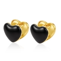 Detailed view of gold heart earrings with black enamel inlay on a white background - Heart / Black