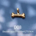 Detail of 18K gold plated bone-shaped pendant with 2x0.9cm dimensions and double-sided design - D08 Golden Bone