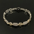 Elegante bracciale geometrico bicolore con placcatura in oro e cristalli su fondo nero - Bracciale Geometrico Bicolore SL542