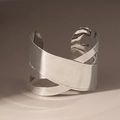 Detailed macro view of the silver irregular geometric layered wrap bangle with a mirror finish - Arm Cuff / Silver