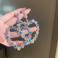 Detailed close-up of oversized hollow heart earrings with colorful sparkling rhinestones - Colorful Heart Rhinestone (Silver Earring Post)