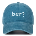 Detail view of a vintage washed denim baseball cap with white "ber?" embroidery. - Lake Blue