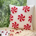 Square white tufted cushion with peppermint candy embroidery and red spirals - Loop Canvas Candy