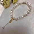 Detail of baroque pearl bracelet with 14K gold clasp and square charm on white background - Pearl Fashion Square Tag Style (SL7-11)