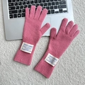 Pink knitted fingerless wool gloves with ribbed cuffs and white fabric labels - One Size / Pink