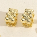 Macro detail of pair of 14K gold plated teddy bear earrings with polished mirror finish - Gold Bear Ear Hoops