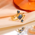 Gold-finished titanium steel open ring featuring emerald-cut blue gemstones on silk - Square Blue Stone Style (JZ26-1)