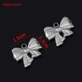 Pendentif nœud en acier inoxydable argenté, dimensions 1,5x1,3cm, trou de 0,2cm - Style F / Acier