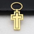 Macro detail of golden double-layer cross keychain with polished metallic texture - Gold