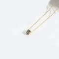 Gold chain necklace with a black cube pendant featuring the golden letter P detail - Letter P
