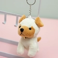 Plush puppy keychain with gold bell and metal ring hanging on a white display rack - 10cm / Off White