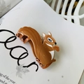 Detail of squirrel shaped acetate hair claw clip with wood grain texture on magazine - Squirrel / Approx 7cm