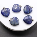 Close-up of five heart-shaped lapis lazuli pendants with golden specks and silver clasps - Natural Lapis Lazuli