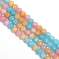 Close-up of mixed colorful glass beads with ice crackle texture for DIY jewelry making - Pink Blue Floral Round Bead