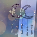 Macro view of handmade moon and butterfly suncatcher with purple amethyst and crystal prisms - Purple Crystal