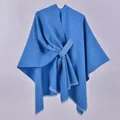 Close-up of royal blue shawl featuring knitted texture, fringe edges and crossover design - White Fringe with Stripe / Blue