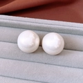 Close-up of large round white pearl earrings in a grey velvet jewelry display box - Silver Pin - Beige