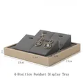Gray jewelry tray detail with four slots for pendant and earring display on a gold frame - 4-Slot Pendant Tray