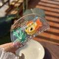 Close-up of a clear fish tank hair claw clip with colorful goldfish and seaweed patterns - Goldfish & Seaweed Transparent Semi-Circle Claw