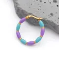 Detail of bohemian hoop earrings with blue and purple beads and gold-plated bamboo accents - Violet Blue