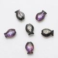 Macro detail of six iridescent fish-shaped crystal beads for DIY jewelry making - Half Gun Black Purple