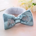 Close-up of soft plush headband featuring light blue OMG! embroidered bow detail - Blue