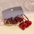 Deep red heart drop earrings and textured hoop set displayed on vintage book background - 6-Piece Set / Red